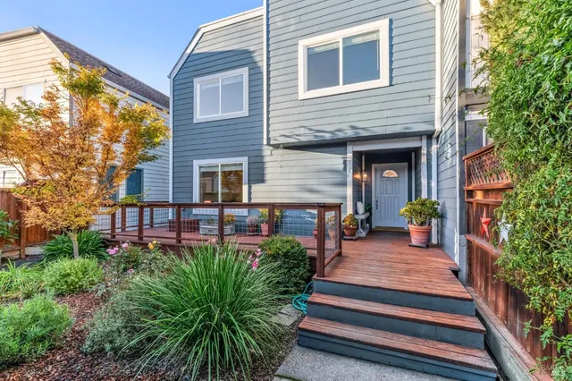 a view of a balcony with wooden floor and iron stairs
