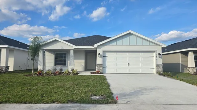 a front view of a house with a yard and garage