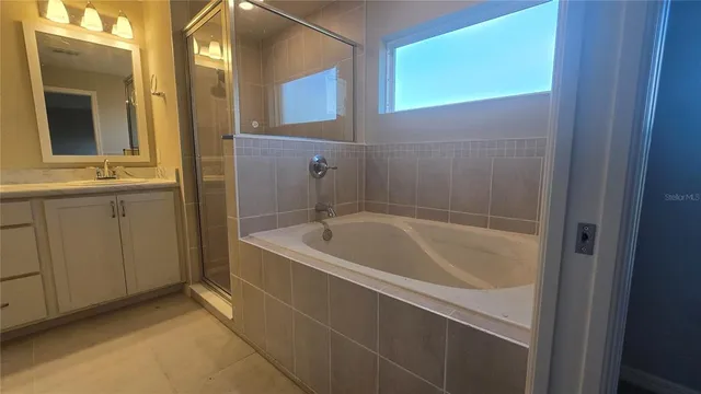 a bathroom with a double vanity sink and mirror