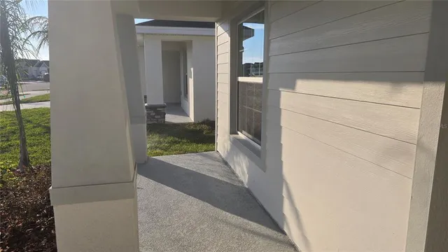a view of a door of the house and trees