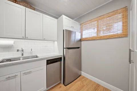 a kitchen with a sink and refrigerator