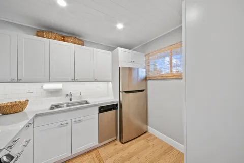 a kitchen with a sink cabinets and stainless steel appliances