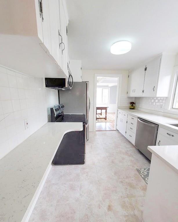 39 Kenneth Road Marblehead, MA 01945 - Photo 13 of 27 a large white kitchen with cabinets