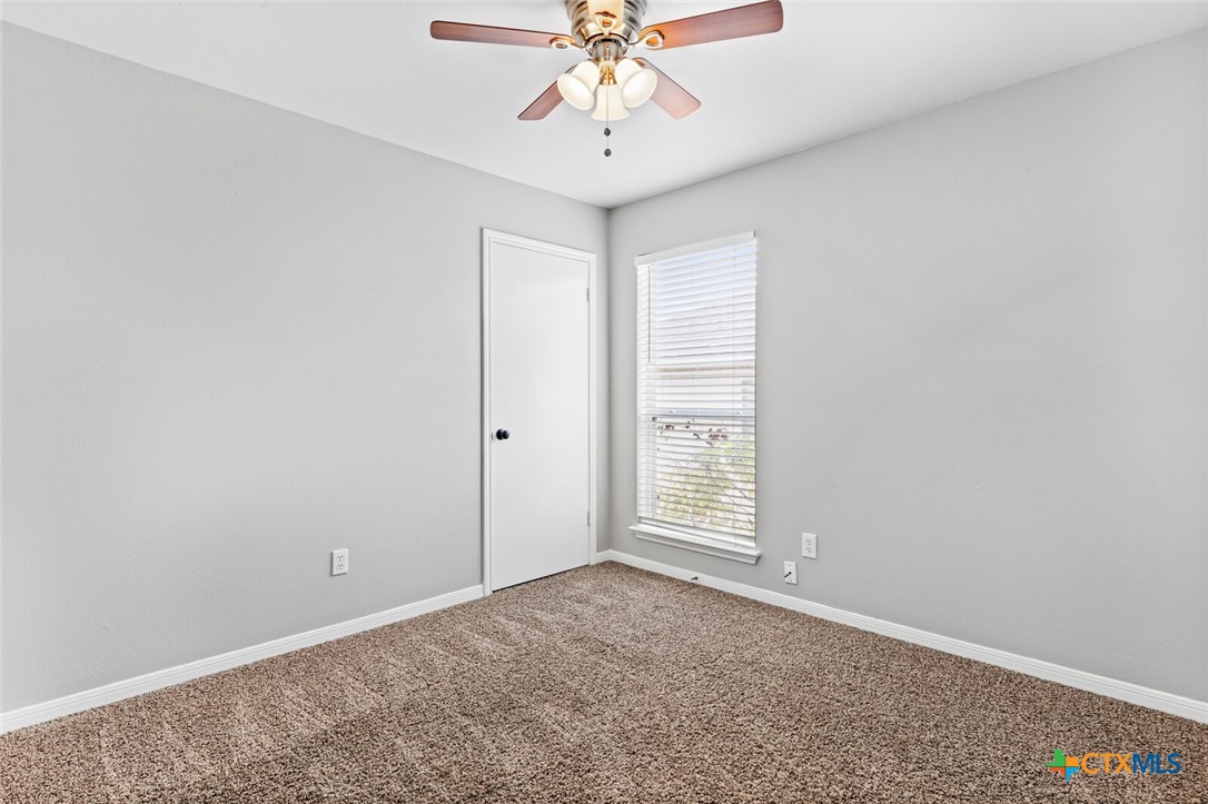 808 Silver Stone Drive Temple, TX 76502 - Photo 22 of 31 an empty room with chandelier fan and windows