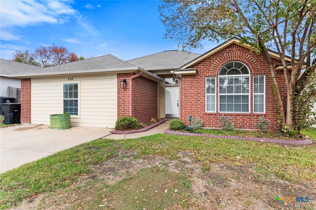 808 Silver Stone Drive Temple, TX 76502 - Photo 3 of 31 a front view of a house with a yard and garage