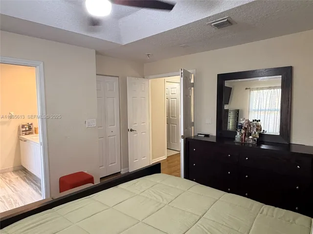 a bedroom with a bed and a dresser