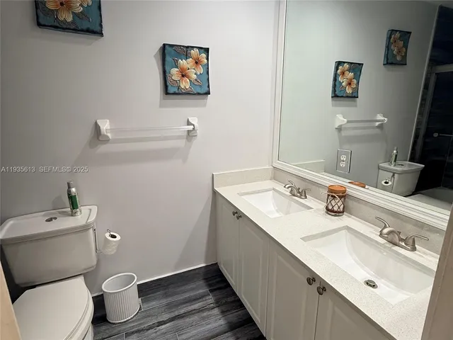 a bathroom with a sink mirror and toilet