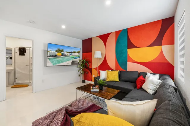 a living room with a couch and painting on the wall