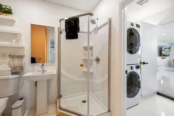a bathroom with a sink a mirror and shower