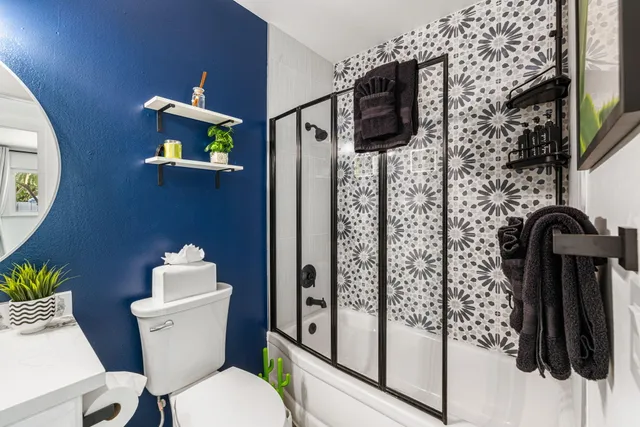 a bathroom with a toilet a sink and shower