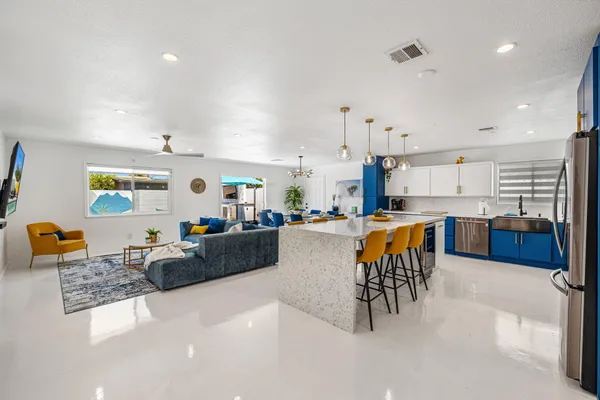 a living room with furniture and kitchen view