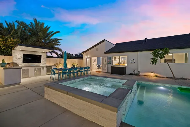 a view of a backyard with a patio and fire pit