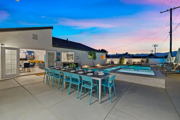 a view of a patio with dining table and chairs with a patio
