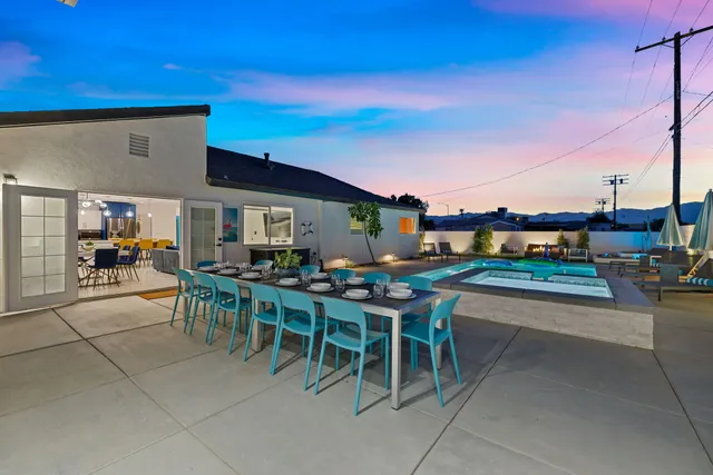 a view of a patio with dining table and chairs with a patio