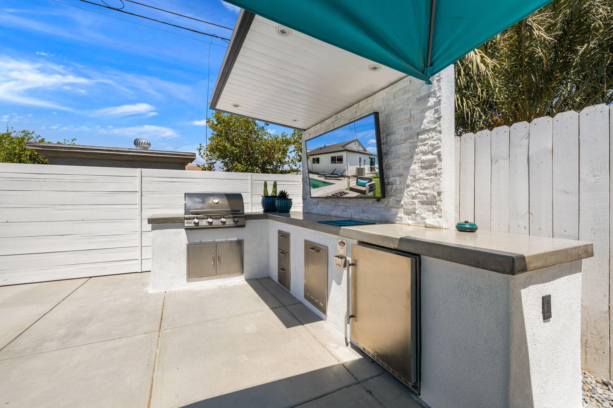82156 Oleander Avenue Indio, CA 92201 - Photo 29 of 32 a kitchen with stainless steel appliances kitchen island granite countertop a sink and cabinets