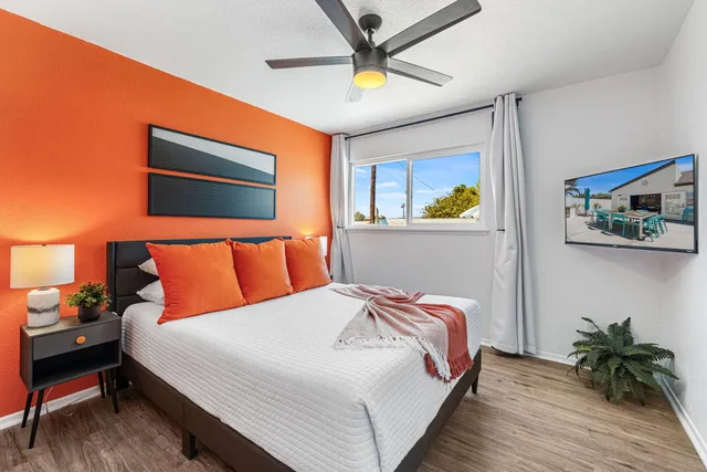 a bedroom with a bed and a chandelier