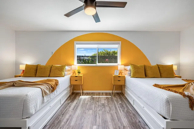 a bedroom with a bed and a view of kitchen