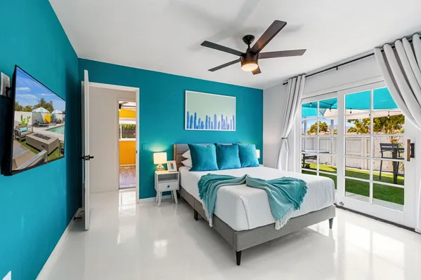 a living room with a bed and a flat screen tv