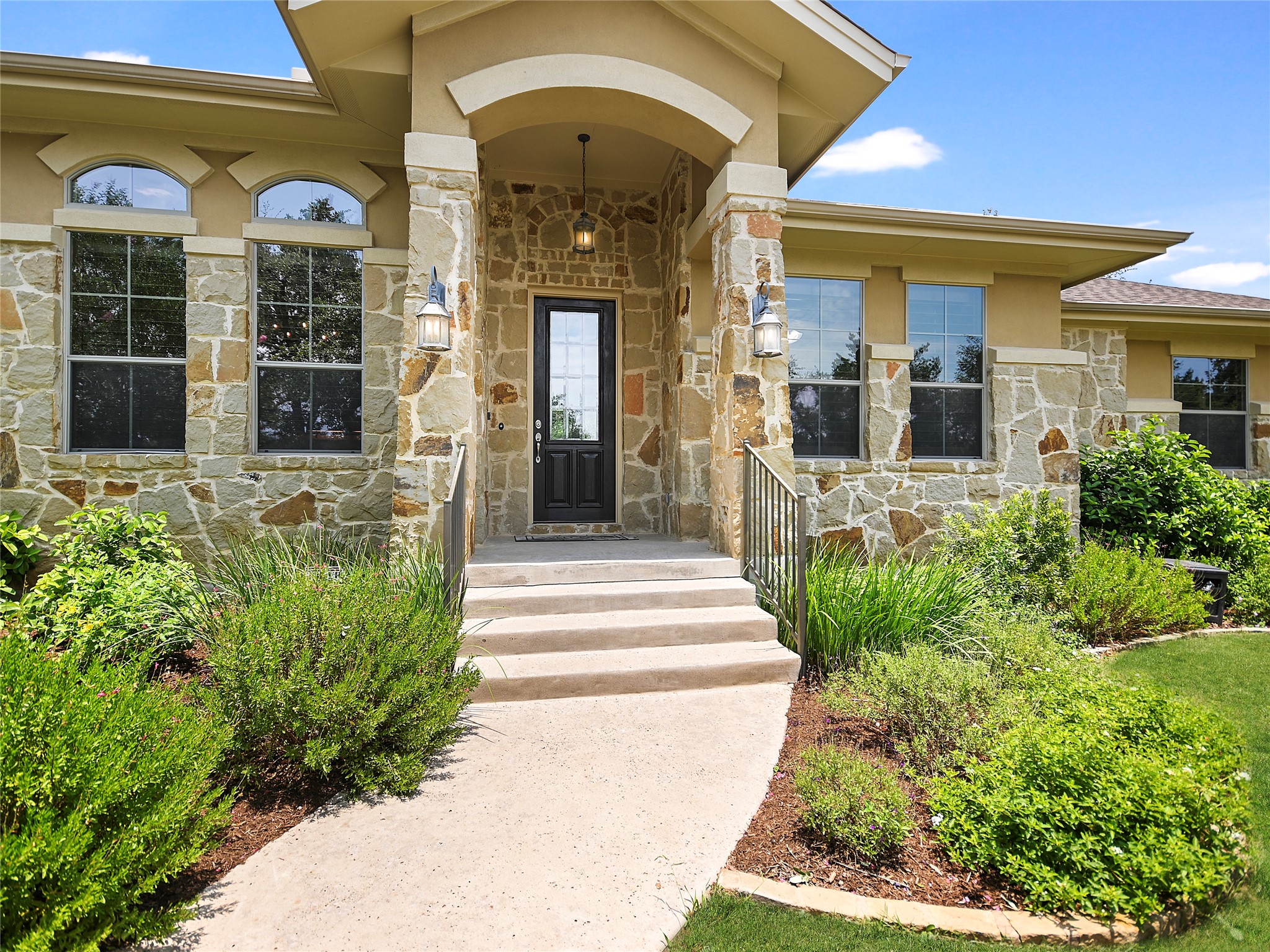 9436 El Rey Boulevard Austin, TX 78737 - Photo 1 of 1 a front view of a house with a garden