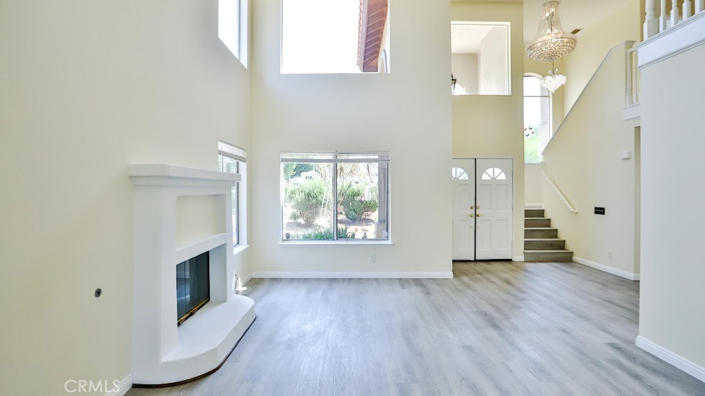 7855 Westpark Drive Riverside, CA 92506 - Photo 9 of 49 a view of an empty room with wooden floor and a window