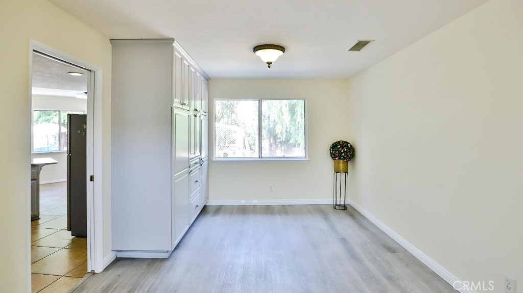 7855 Westpark Drive Riverside, CA 92506 - Photo 11 of 49 wooden floor in an empty room with a window