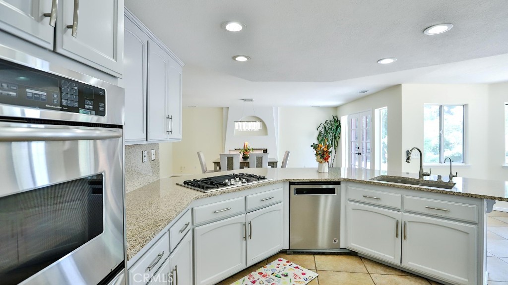 7855 Westpark Drive Riverside, CA 92506 - Photo 13 of 49 a kitchen with a sink stove and cabinets