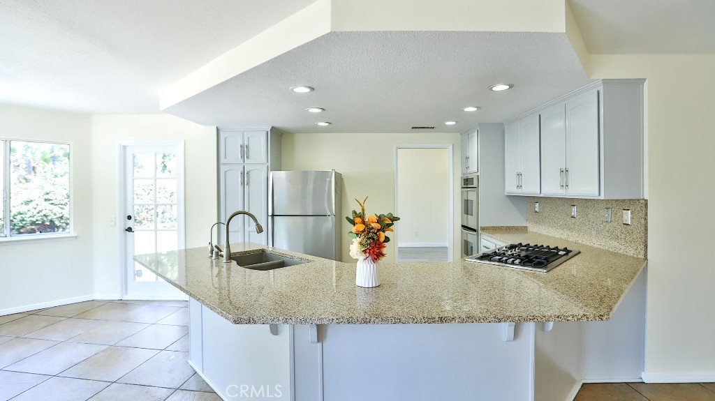 7855 Westpark Drive Riverside, CA 92506 - Photo 15 of 49 a kitchen with stainless steel appliances granite countertop a sink and cabinets