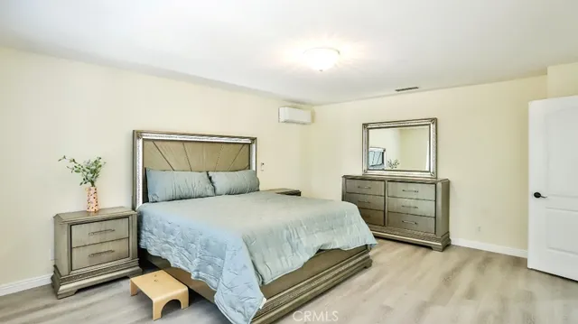 a view of a hallway with wooden floor and a chandelier