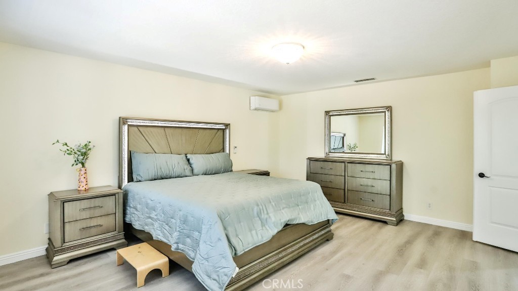 7855 Westpark Drive Riverside, CA 92506 - Photo 25 of 49 a bedroom with a bed and a dresser