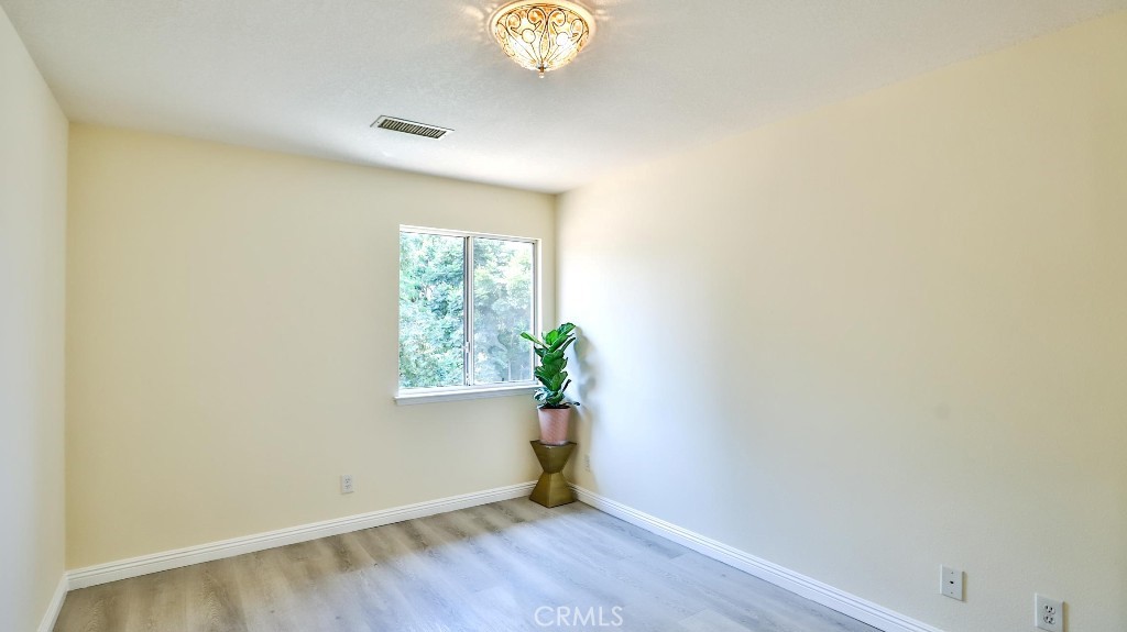 7855 Westpark Drive Riverside, CA 92506 - Photo 32 of 49 a view of an empty room with window and wooden floor