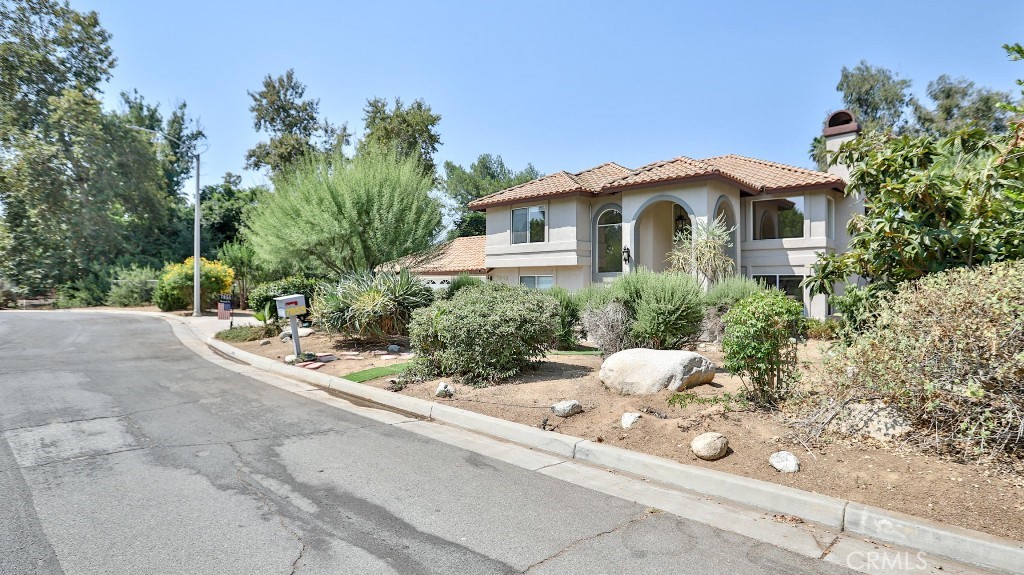 7855 Westpark Drive Riverside, CA 92506 - Photo 3 of 49 a front view of a house with a yard and potted plants
