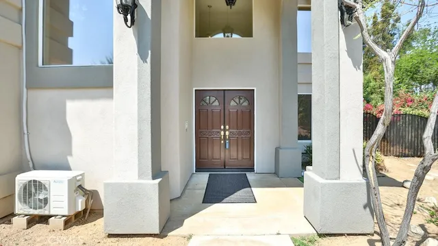 a picture of a bathroom with a white wall and a picture of a painting