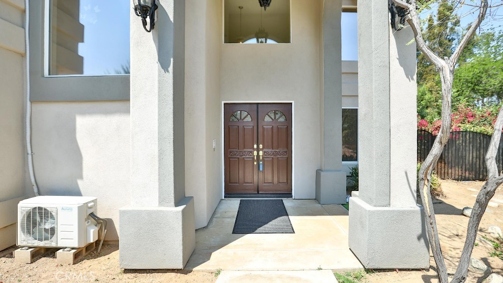 7855 Westpark Drive Riverside, CA 92506 - Photo 5 of 49 a living room with a couch and a potted plant