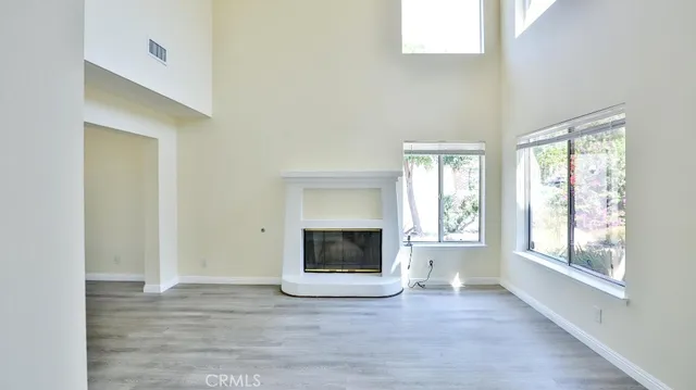 a front view of a house with a yard and potted plants