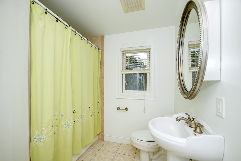 33 Damon Road Scituate, MA 02066 - Photo 19 of 29 a bathroom with a sink a toilet and a mirror