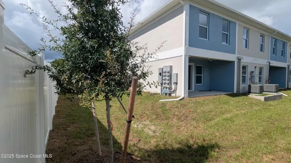 a view of yellow house with a tree