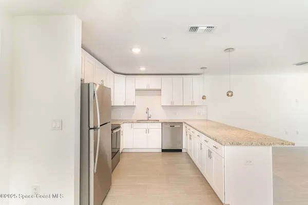 a kitchen with a refrigerator a sink and dishwasher