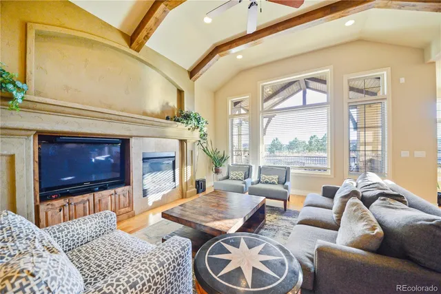 a living room with furniture a window and a fireplace