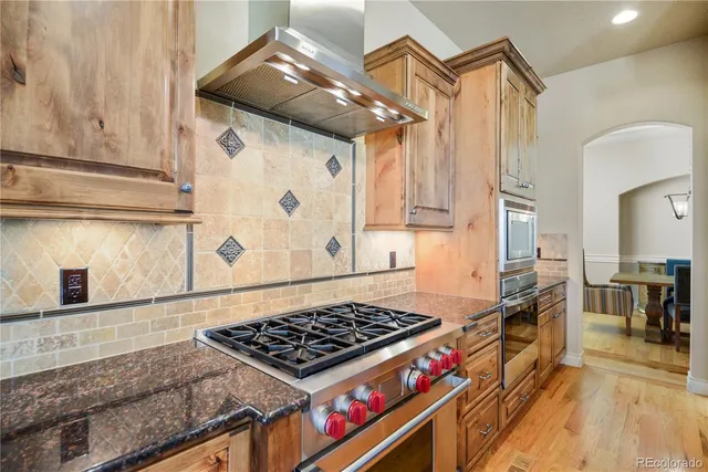 a kitchen with stainless steel appliances granite countertop a stove and a sink