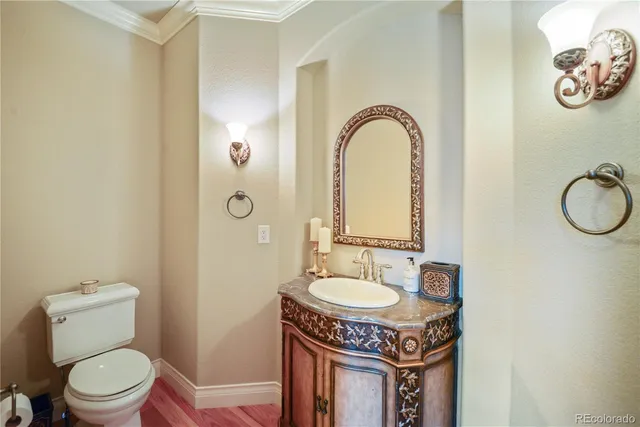 a spacious bathroom with a granite countertop sink a toilet and a mirror
