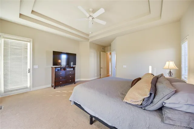 a bedroom with a bed and a flat tv screen on dresser