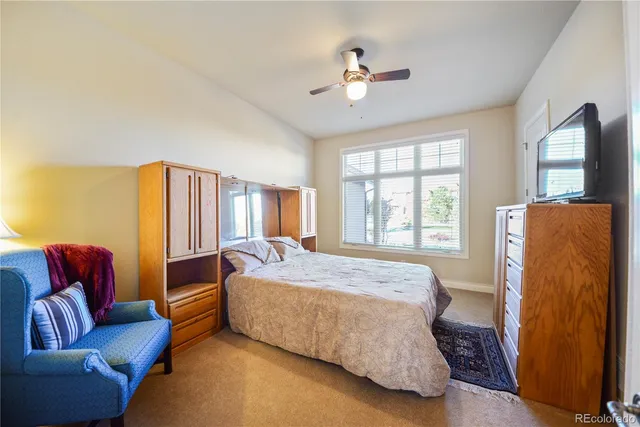 a bedroom with a bed couch and window