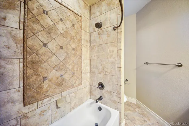 a bathroom with a bathtub and shower