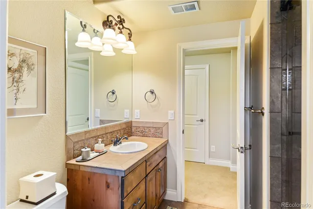 a bathroom with a sink vanity mirror and a bathtub
