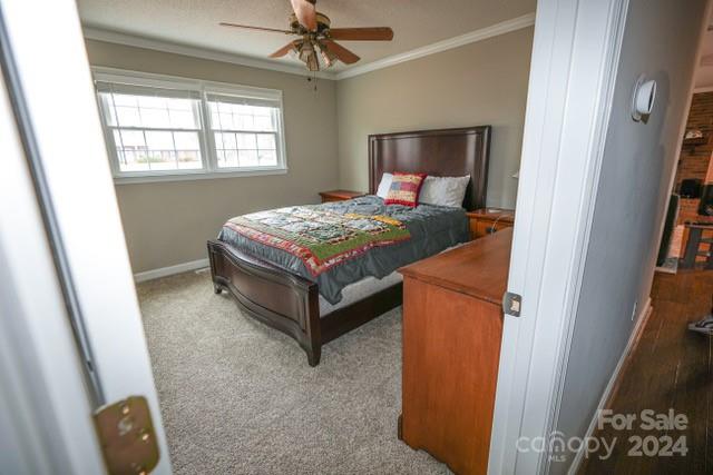 957 State Rd S-29-38 Lancaster, SC 29720 - Photo 16 of 25 a bedroom with a bed and a chandelier