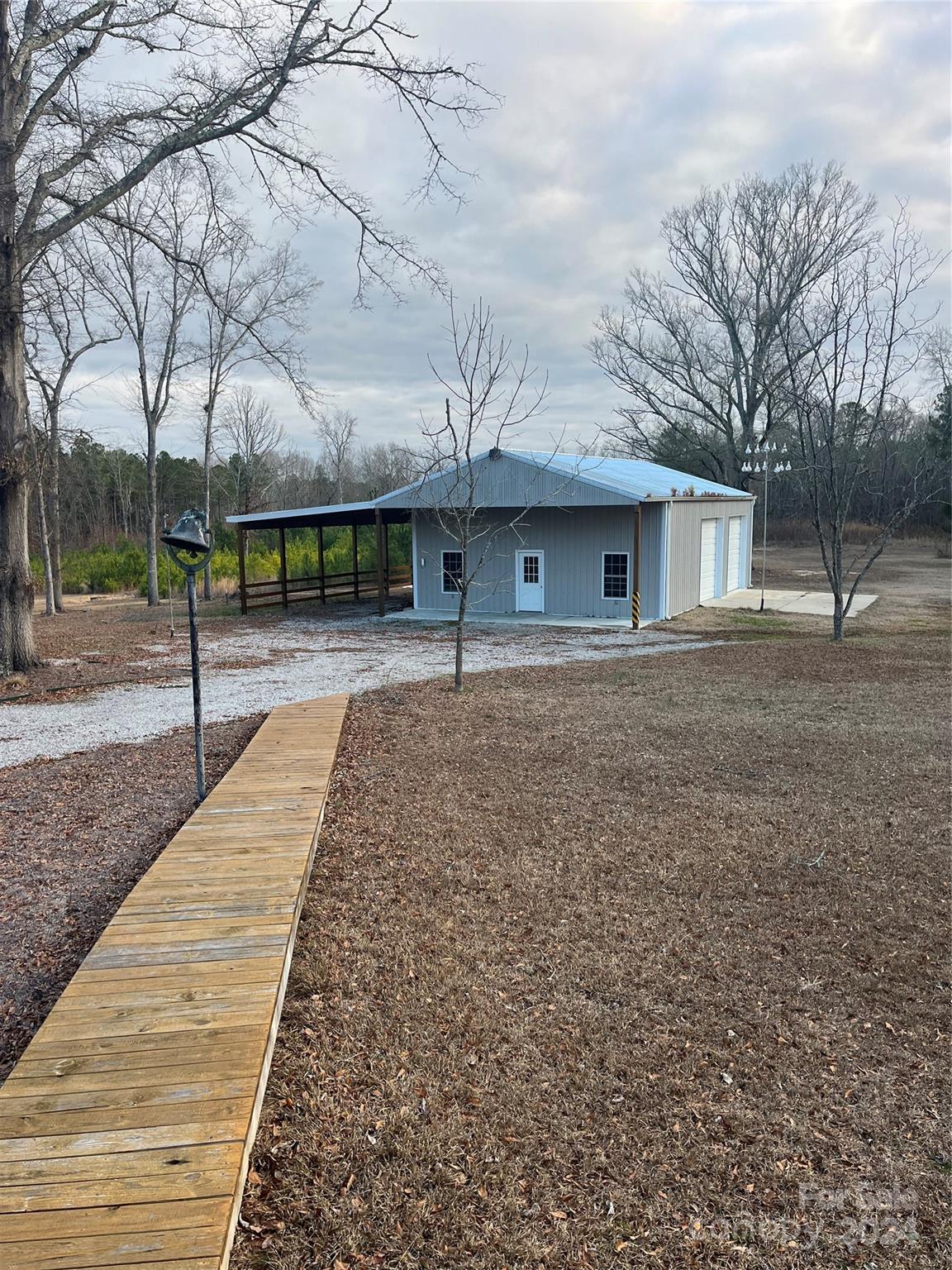 957 State Rd S-29-38 Lancaster, SC 29720 - Photo 21 of 25 a house with trees in front of it