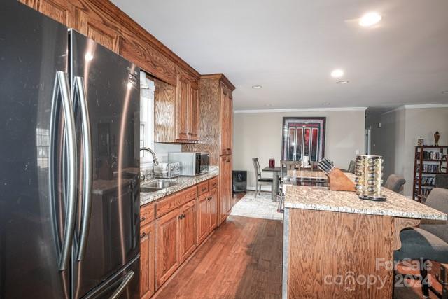 957 State Rd S-29-38 Lancaster, SC 29720 - Photo 9 of 25 a kitchen with stainless steel appliances granite countertop a refrigerator a sink dishwasher a dining table and chairs with wooden floor