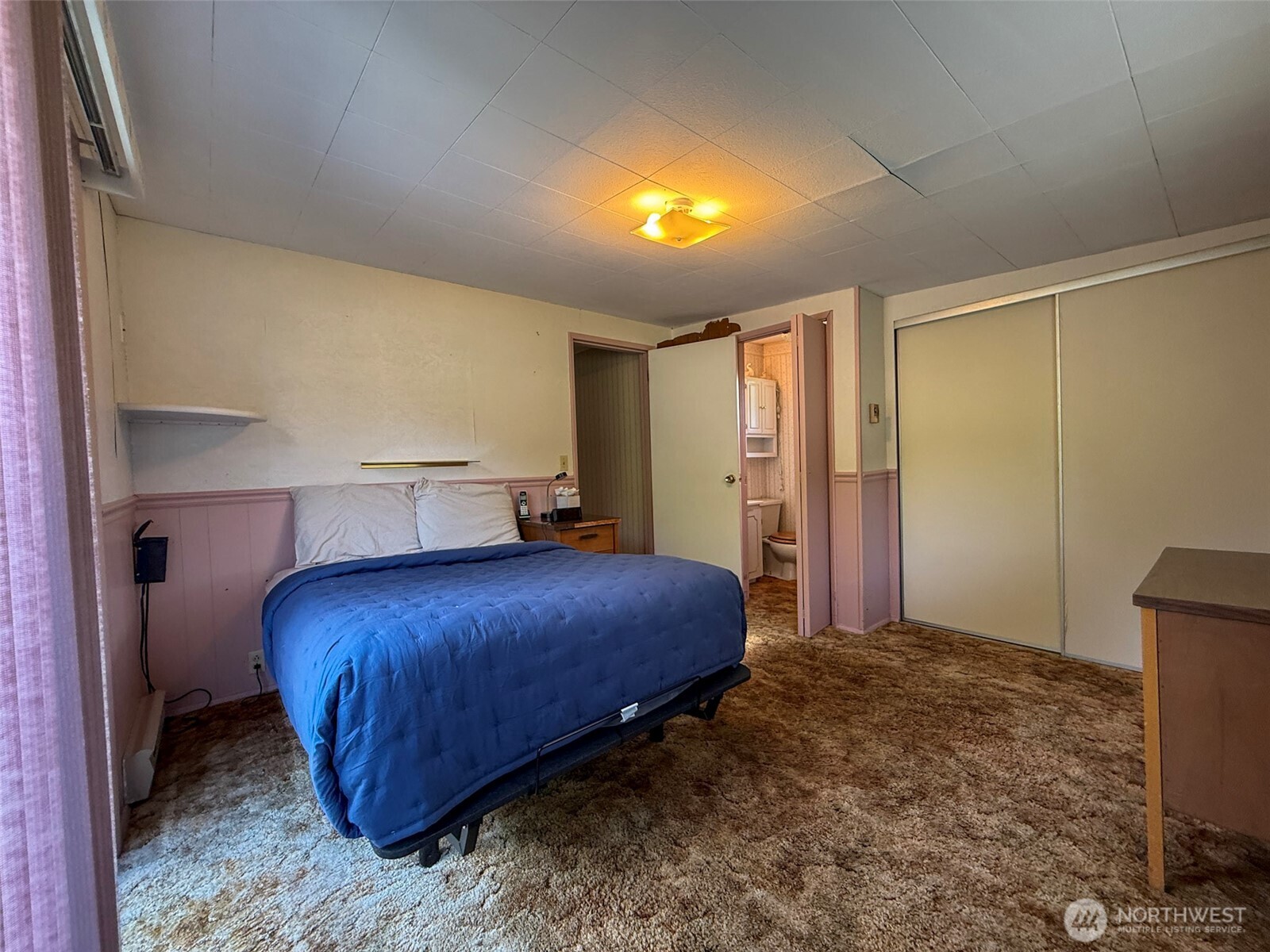 518 Bridge Street Twisp, WA 98856 - Photo 22 of 40 a bedroom with a bed and a potted plant