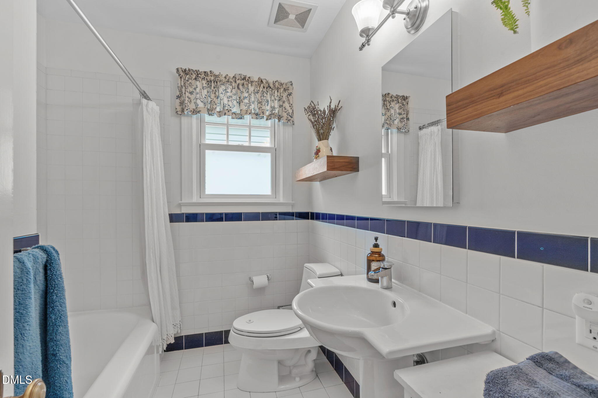 2111 Pershing Street Durham, NC 27705 - Photo 31 of 59 a bathroom with a sink a toilet and a mirror