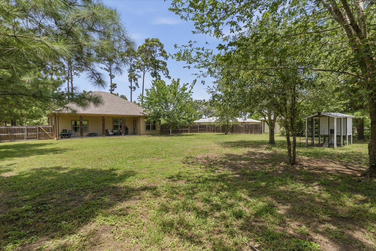 145 Cardinal Loop Paige, TX 78659 - Photo 36 of 40 A spacious, verdant yard provides ample room for outdoor recreation and relaxation.